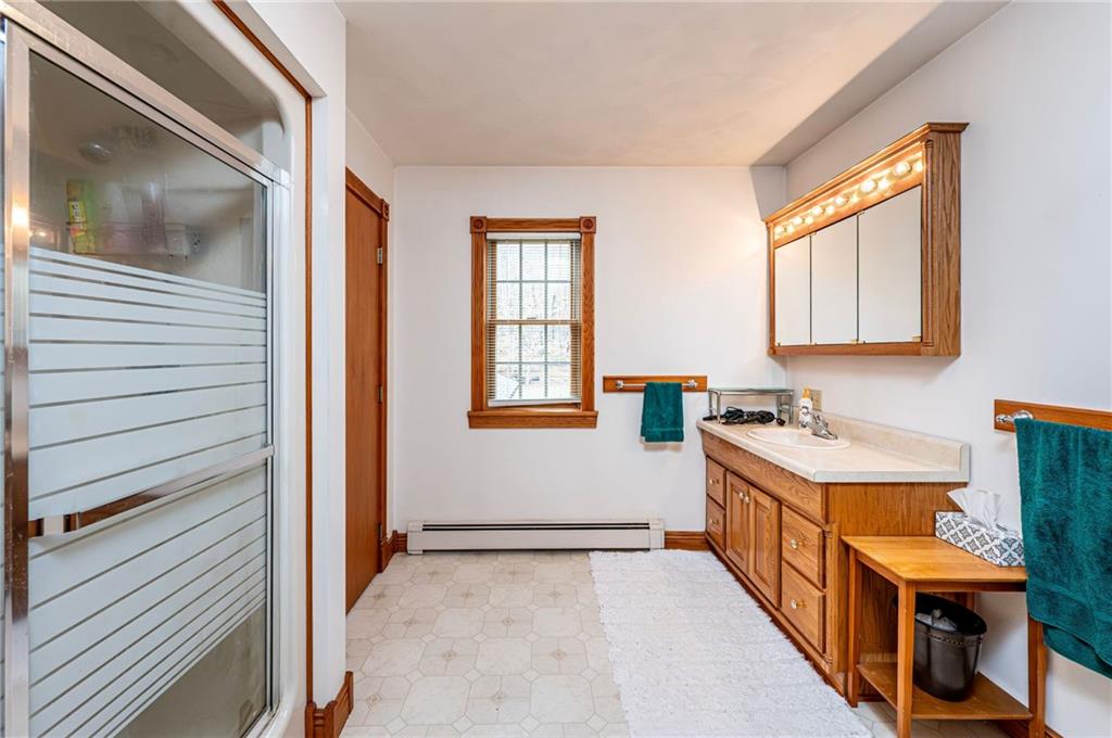 120 Youngstown Ridge Road Ligonier, PA 15658 - Photo 32 of 50 a bathroom with a sink a mirror and a window