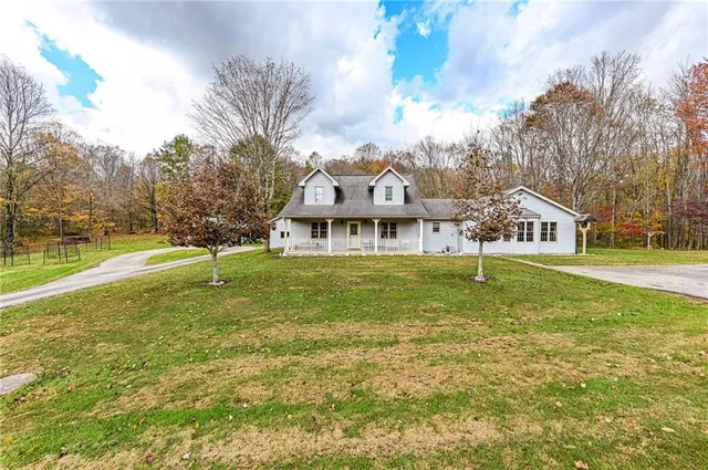 a view of house with outdoor space and sitting area