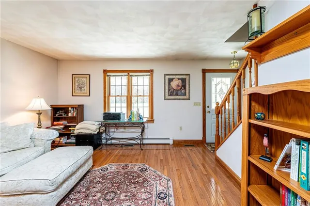 a living room with furniture fireplace and a window