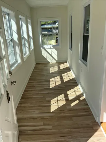 a view of entryway and hall with wooden floor