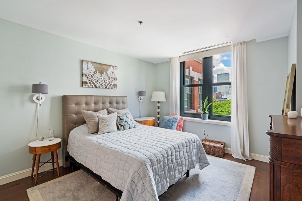 9 West Broadway, Unit 500 Boston, MA 02127 - Photo 12 of 21 a bedroom with bed and wooden floor