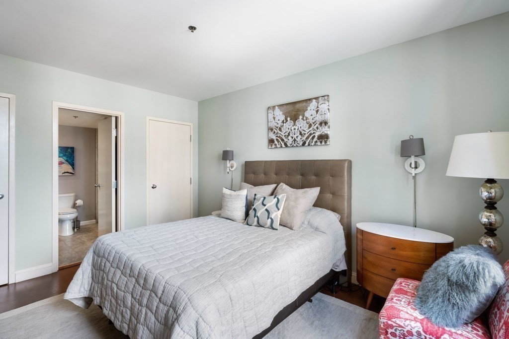 9 West Broadway, Unit 500 Boston, MA 02127 - Photo 14 of 21 a bedroom with bed and a lamp on dresser