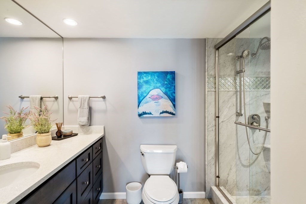 9 West Broadway, Unit 500 Boston, MA 02127 - Photo 15 of 21 a bathroom with a granite countertop sink toilet and shower