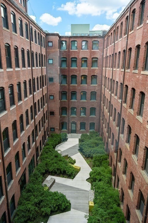 9 West Broadway, Unit 500 Boston, MA 02127 - Photo 20 of 21 a view of front of brick building with windows and yard