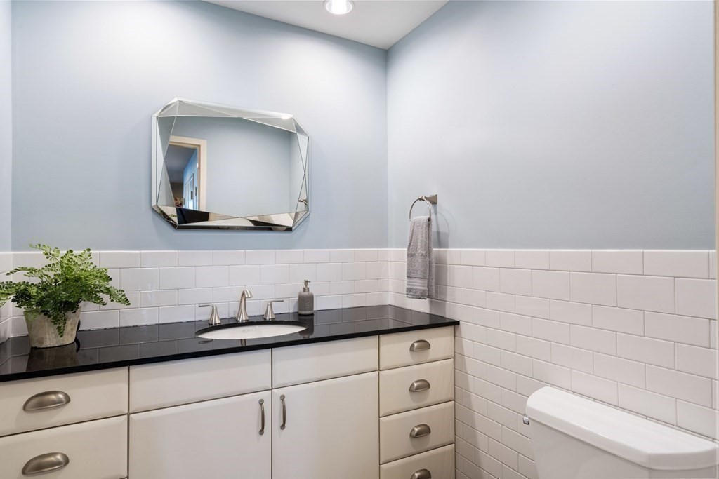 9 West Broadway, Unit 500 Boston, MA 02127 - Photo 21 of 21 a bathroom with a toilet a sink and mirror