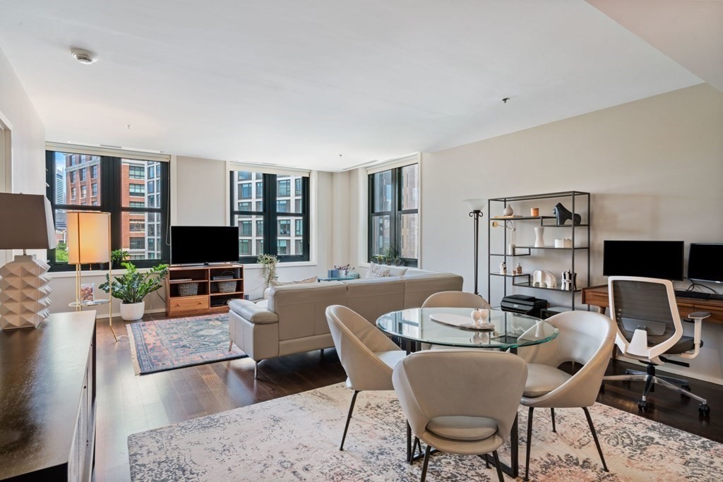 9 West Broadway, Unit 500 Boston, MA 02127 - Photo 4 of 21 a living room with furniture a flat screen tv and a large window
