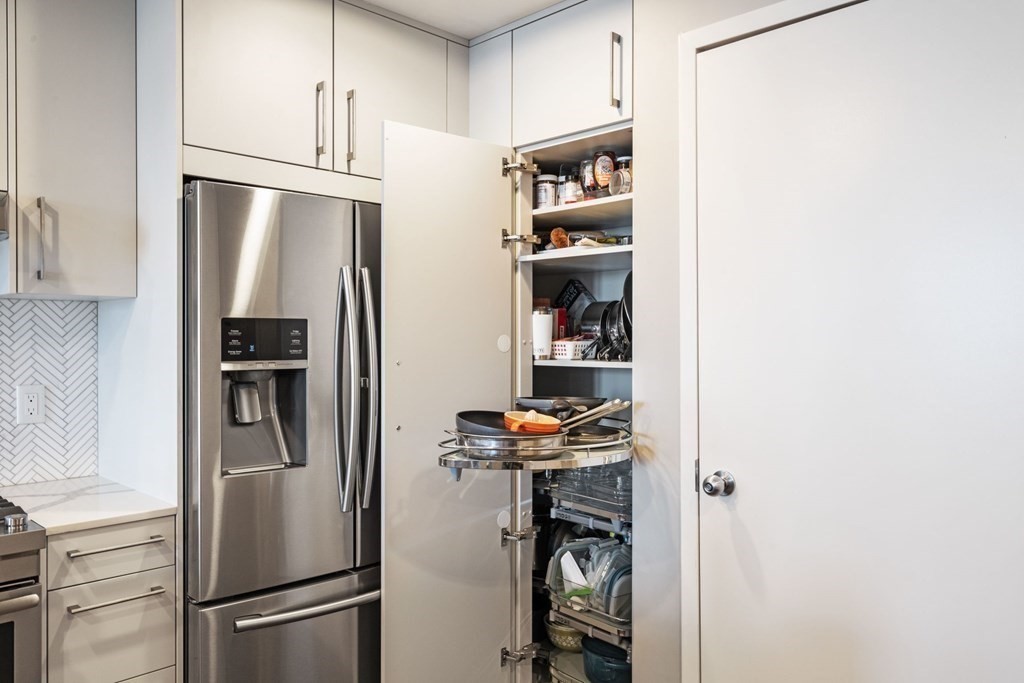 9 West Broadway, Unit 500 Boston, MA 02127 - Photo 9 of 21 a view of a refrigerator and wooden floor