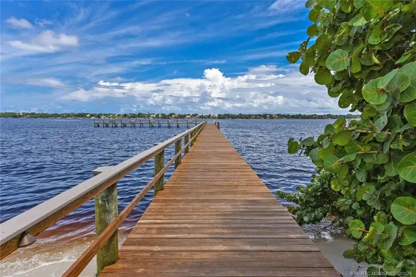 a view of swimming pool with wooden bridge