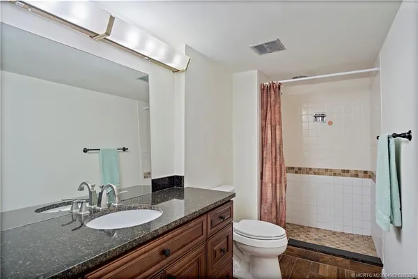 a bedroom with a bed and a couch