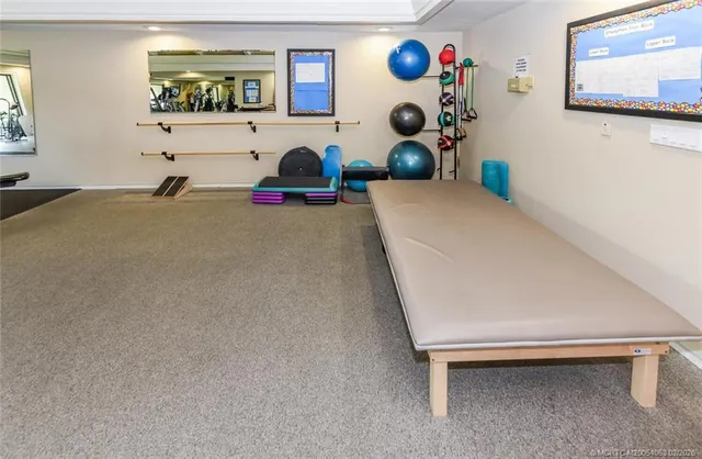 a dining room with furniture and a floor to ceiling window