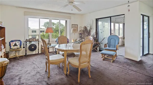 a dining room with furniture and wooden floor