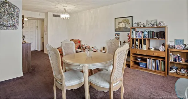 a kitchen with a refrigerator a stove top oven a sink and cabinets