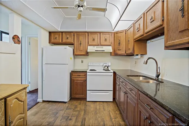 a kitchen with stainless steel appliances granite countertop a sink and cabinets