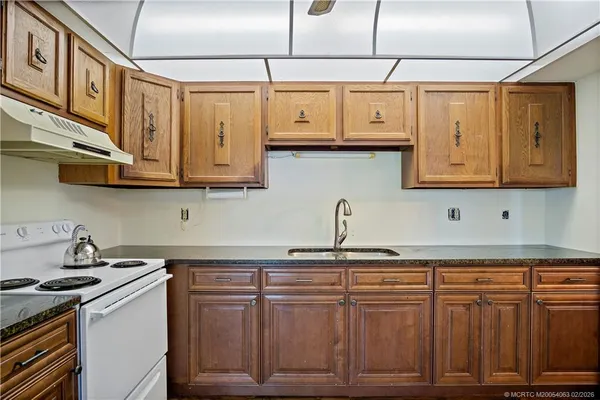 a kitchen with cabinets and wooden floor