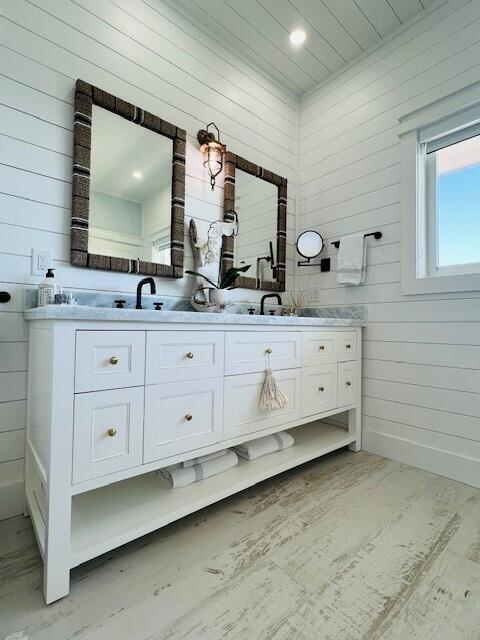 358 Stirrup Key Boulevard Marathon, FL 33050 - Photo 14 of 29 a bathroom with a double vanity sink a mirror and a bathtub