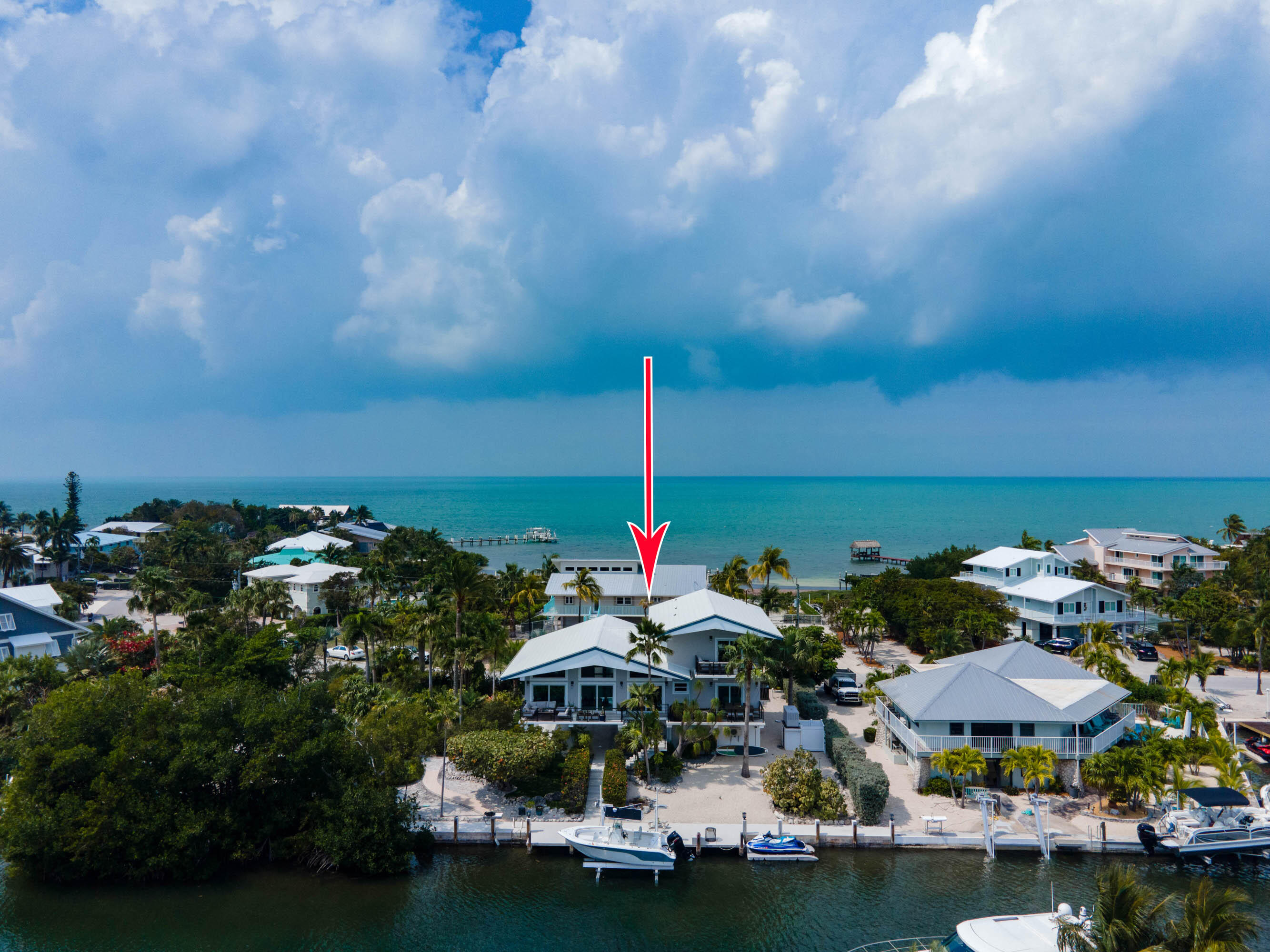 358 Stirrup Key Boulevard Marathon, FL 33050 - Photo 27 of 29 a backyard of a house with lots of green space and lake view in back