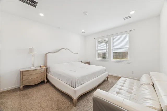 a bedroom with bed and a window