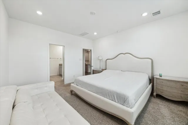 a bedroom with a bed and a night stand