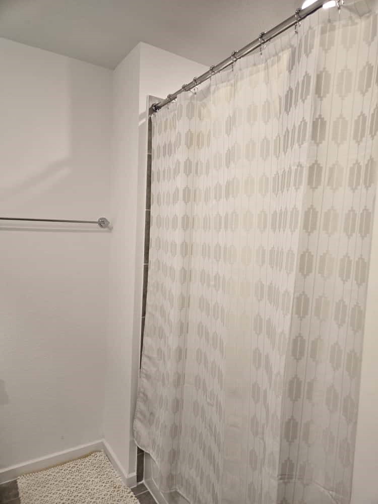 7122 Clearwater Cv Drive Cypress, TX 77433 - Photo 9 of 10 a bathroom with a shower curtain and a shower curtain