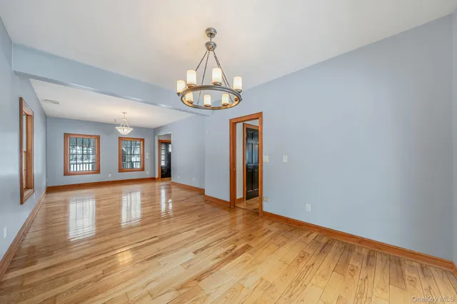a view of empty room with wooden floor and stove