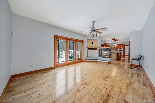 a view of an empty room with a fireplace