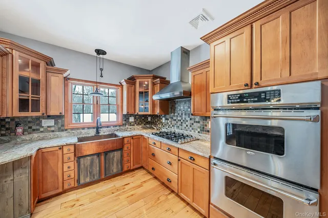 a kitchen with stainless steel appliances granite countertop a stove and a sink