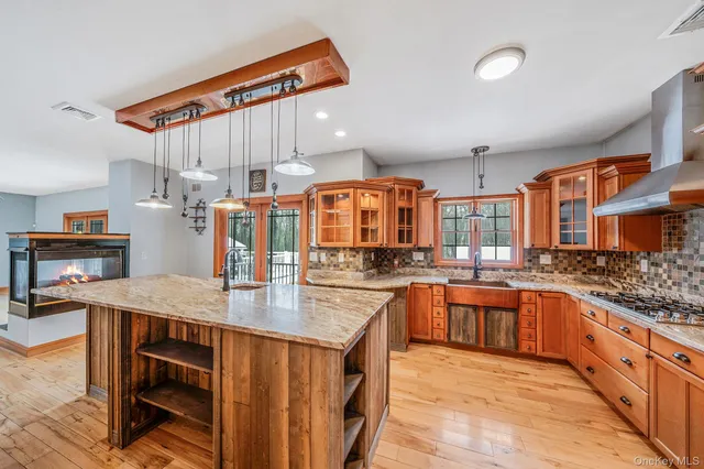 a kitchen with stainless steel appliances granite countertop a sink and cabinets