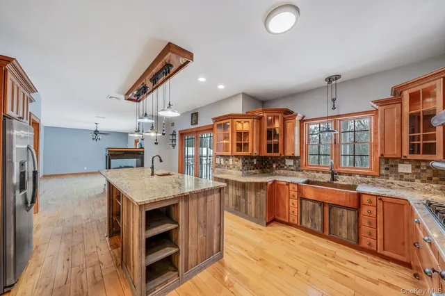 a kitchen with stainless steel appliances granite countertop a stove oven and a refrigerator