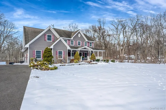 a view of house with outdoor space and sitting area