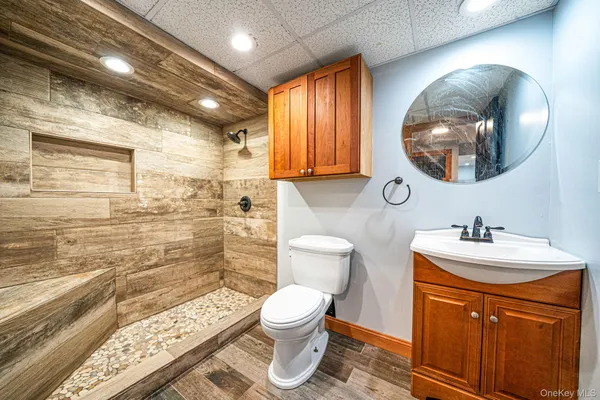 a bathroom with a sink a toilet and a mirror