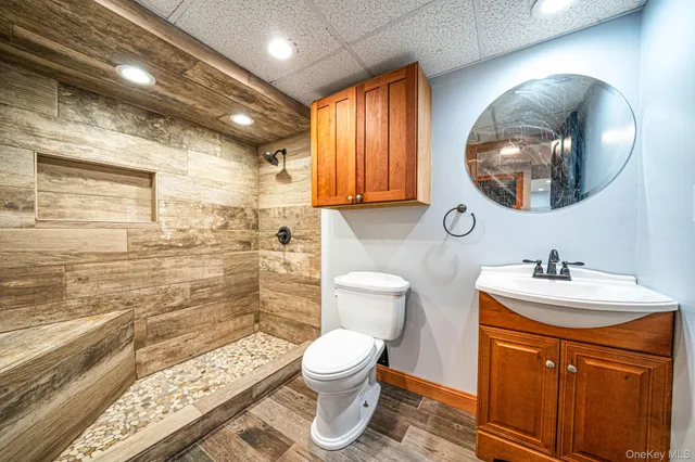 a bathroom with a sink a toilet and a mirror