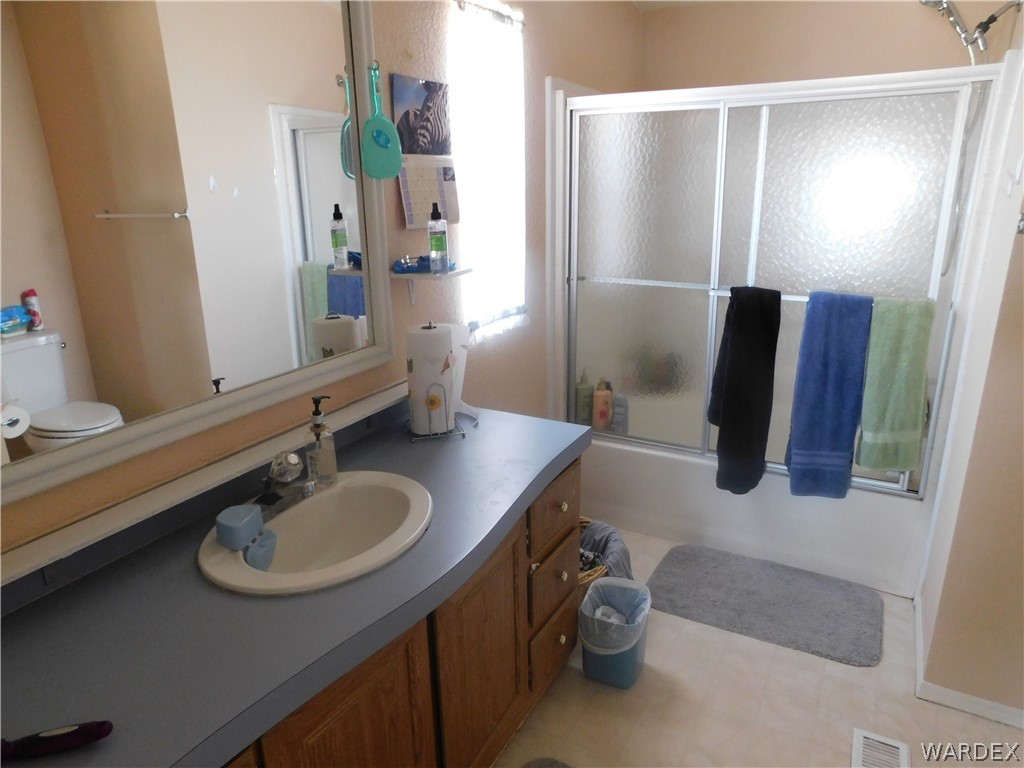 3744 Alpine Road Golden Valley, AZ 86413 - Photo 24 of 27 a bathroom with a sink double vanity and a mirror