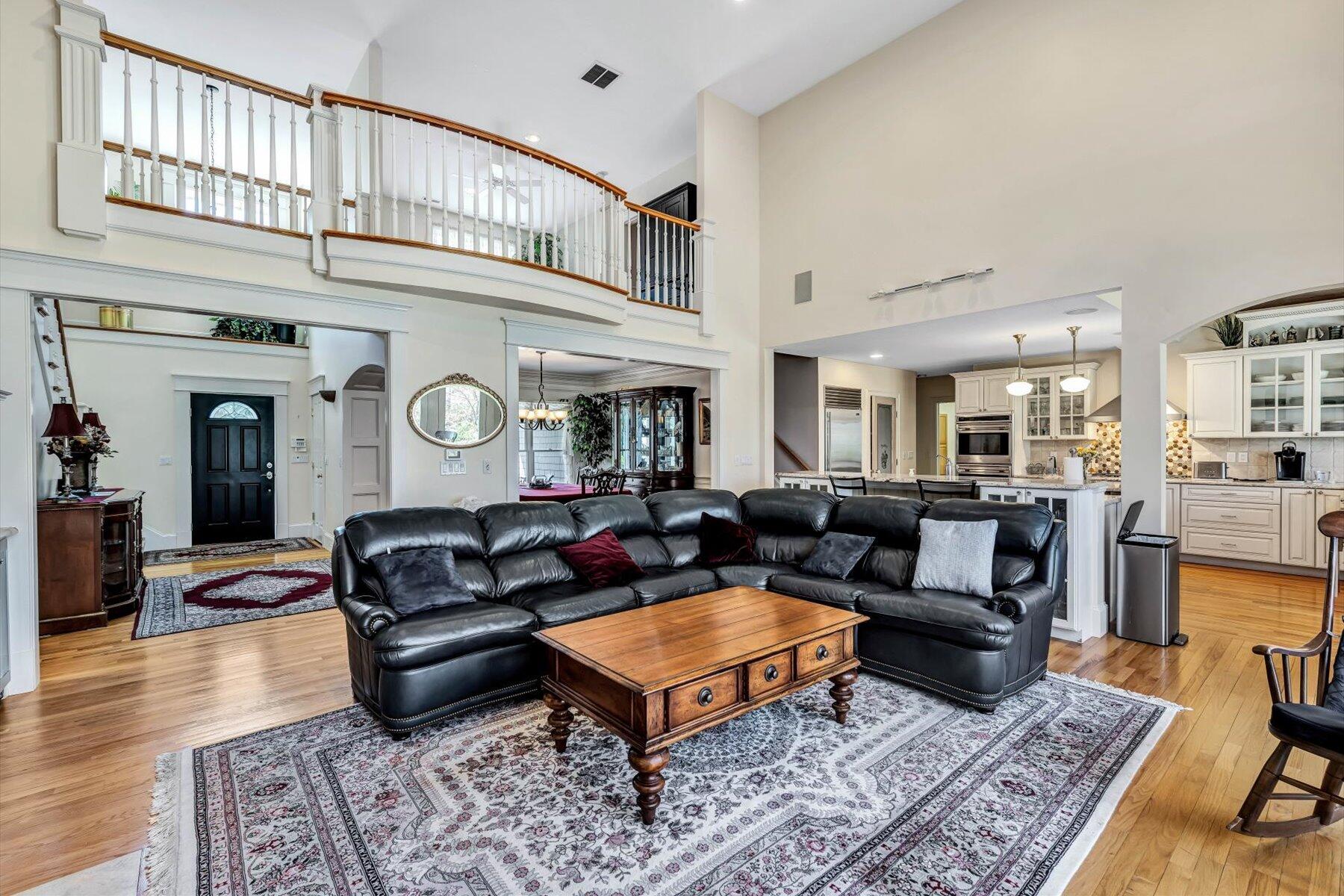 11 Reflection Drive Sandwich, MA 02563 - Photo 20 of 44 a living room with furniture a rug and a clock
