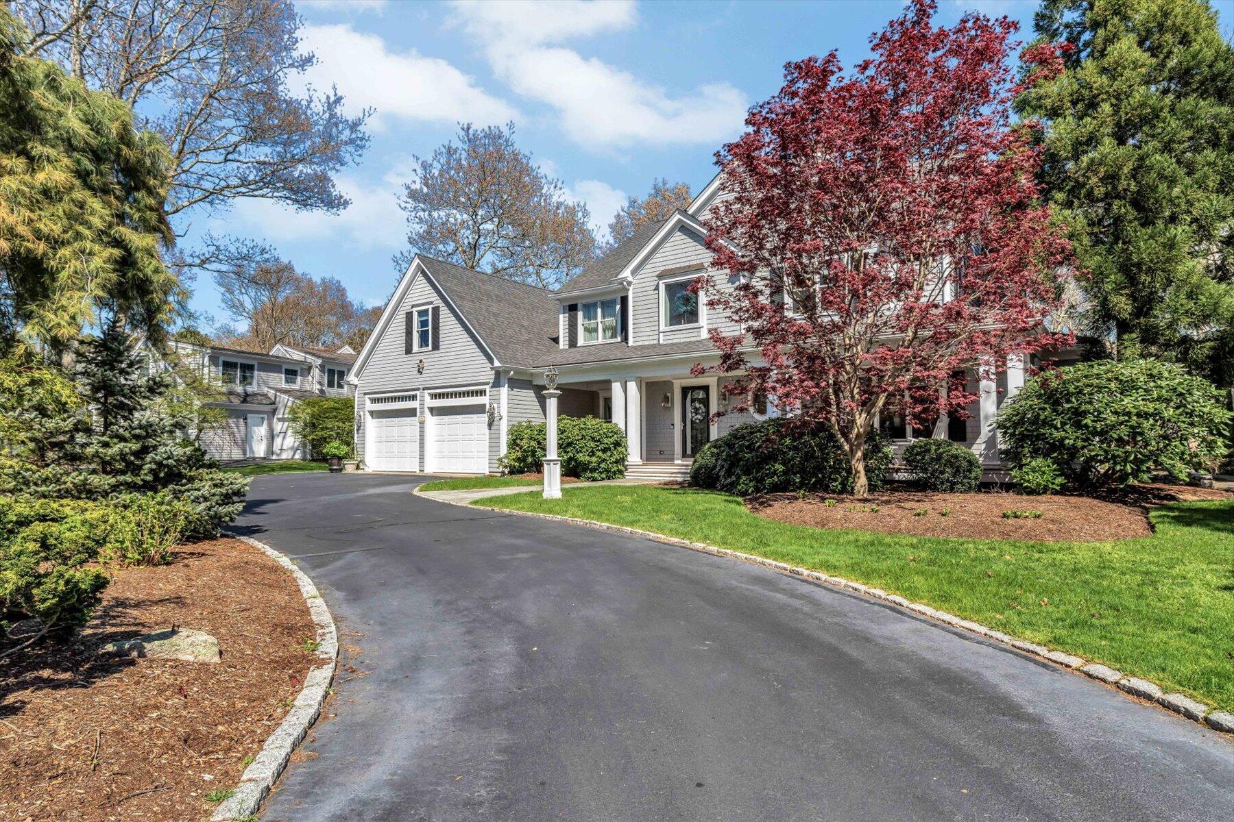 11 Reflection Drive Sandwich, MA 02563 - Photo 2 of 44 a front view of a house with a yard and garage