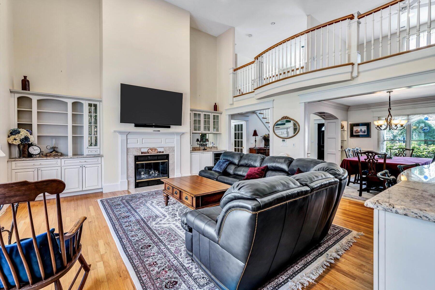 11 Reflection Drive Sandwich, MA 02563 - Photo 21 of 44 a living room with fireplace furniture and a flat screen tv