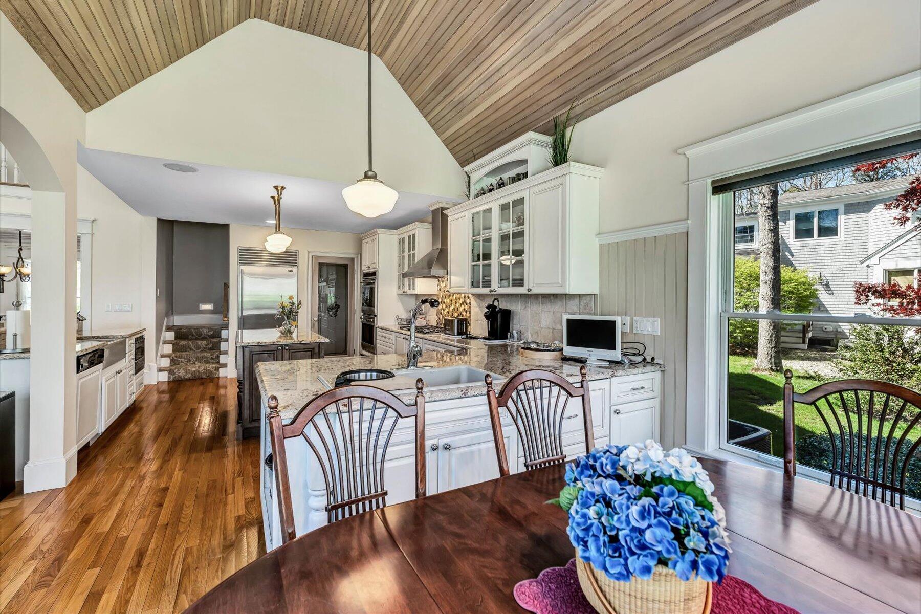 11 Reflection Drive Sandwich, MA 02563 - Photo 28 of 44 a view of a dining room with furniture a chandelier and wooden floor