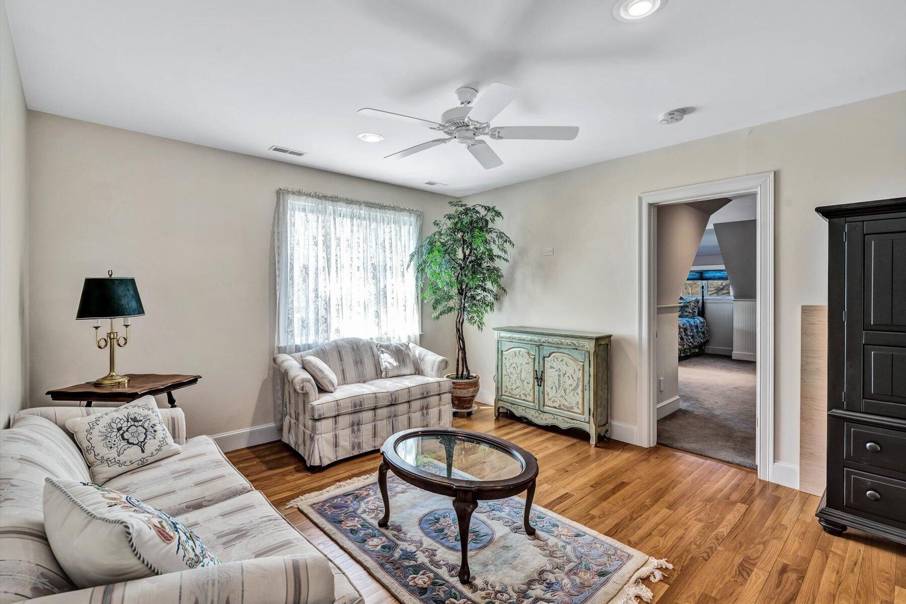 11 Reflection Drive Sandwich, MA 02563 - Photo 36 of 44 a living room with furniture and a wooden floor