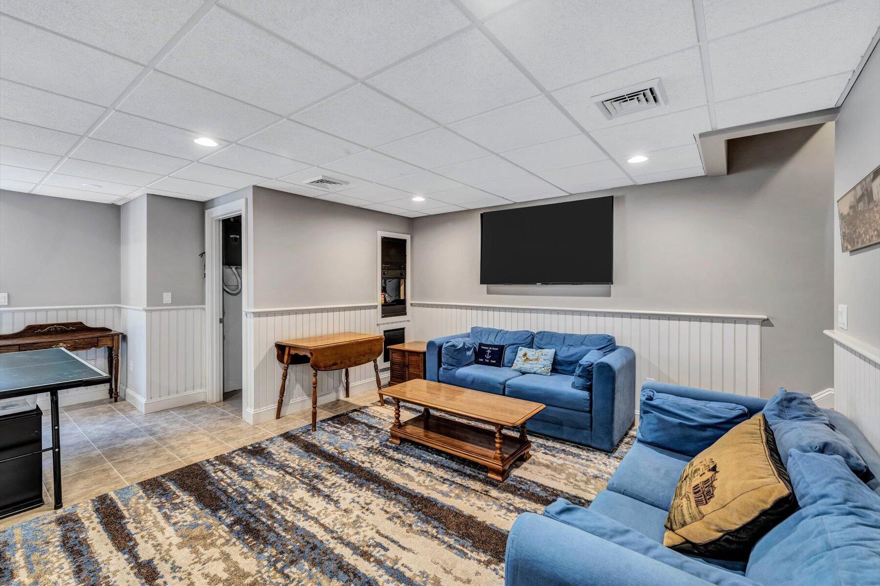 11 Reflection Drive Sandwich, MA 02563 - Photo 38 of 44 a living room with furniture and a flat screen tv