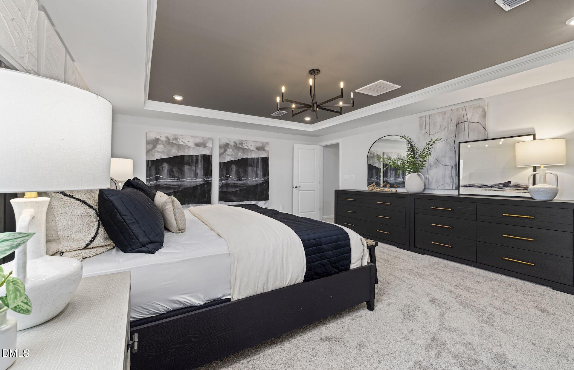 613 Ben Ledi Court Raleigh, NC 27603 - Photo 11 of 32 a bedroom with a large bed and a dresser