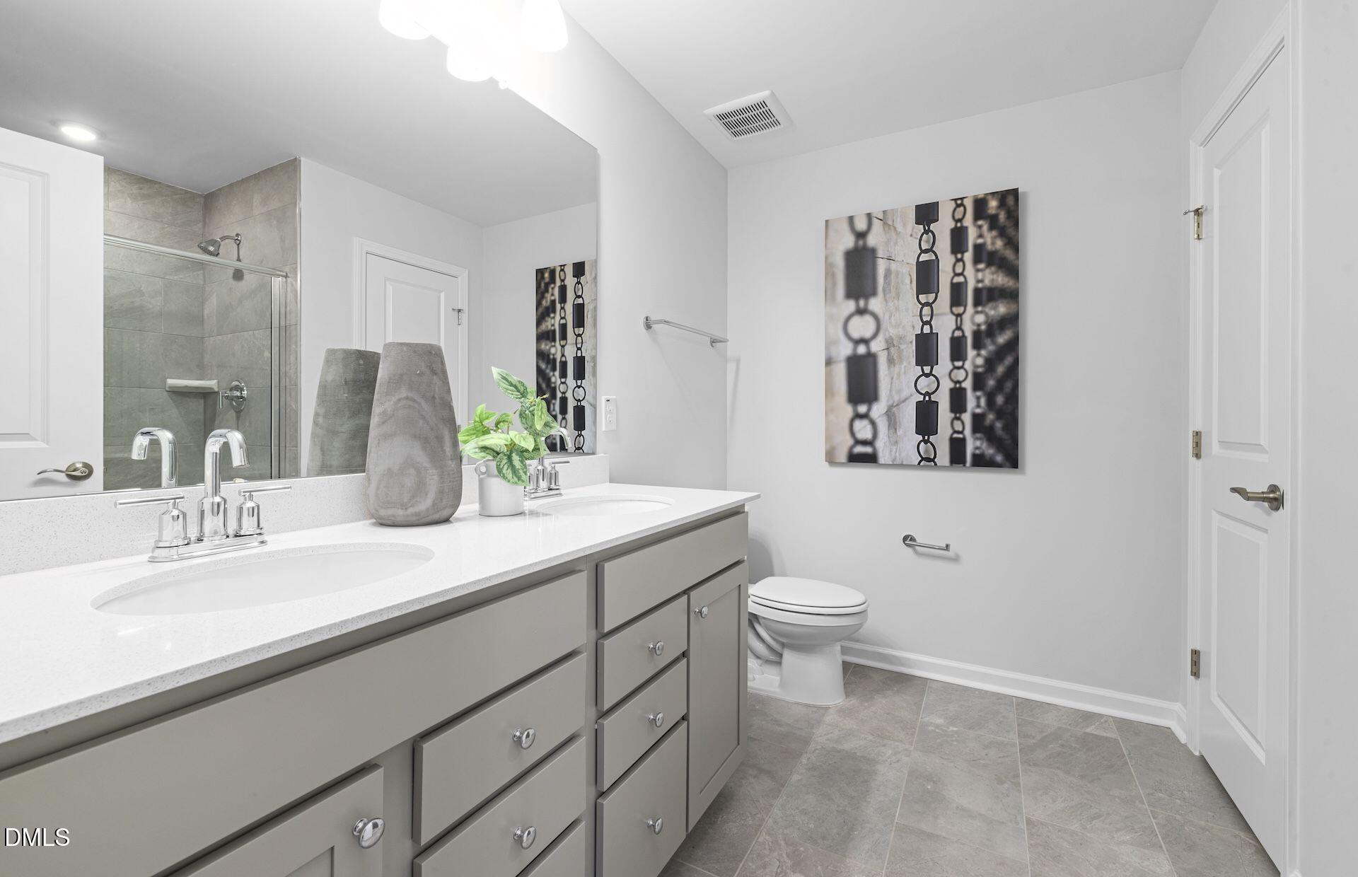 613 Ben Ledi Court Raleigh, NC 27603 - Photo 12 of 32 a bathroom with a granite countertop sink mirror and toilet