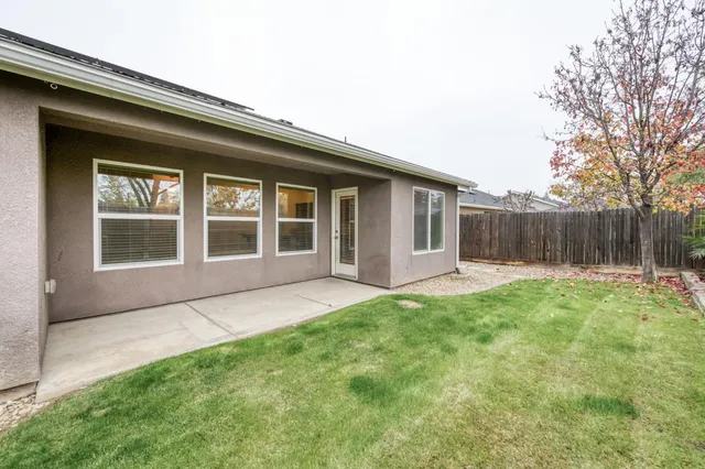 a view of a house with backyard and porch