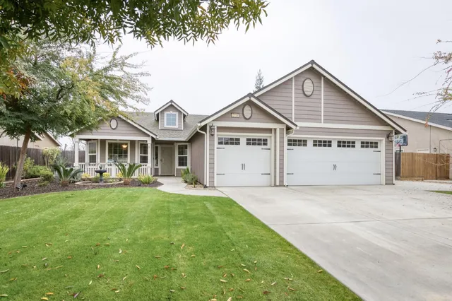 a front view of a house with sitting area and garden