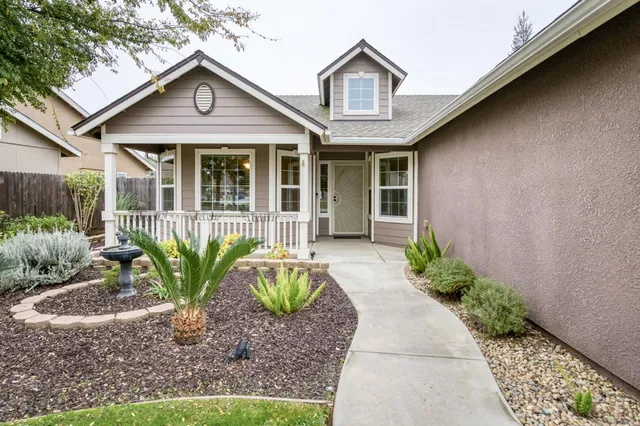 a front view of a house with garden