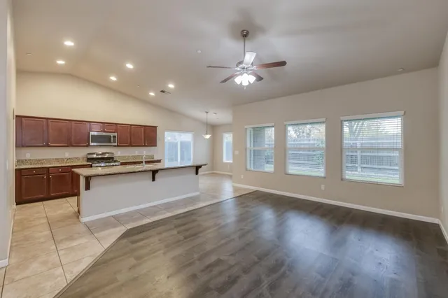 a large kitchen with a large window and stainless steel appliances