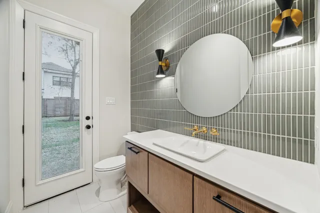 a bathroom with a sink mirror and toilet