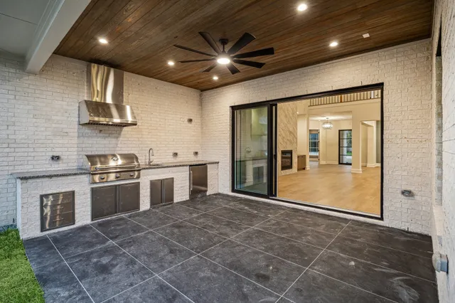 a large kitchen with stainless steel appliances granite countertop a stove a sink and a refrigerator