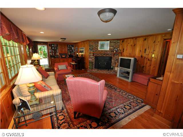4324 Croatan Road Richmond, VA 23235 - Photo 13 of 22 a living room with furniture a flat screen tv and a fireplace