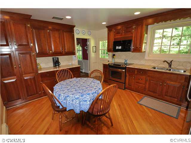4324 Croatan Road Richmond, VA 23235 - Photo 7 of 22 a kitchen with stainless steel appliances granite countertop a sink counter space and a view of living room