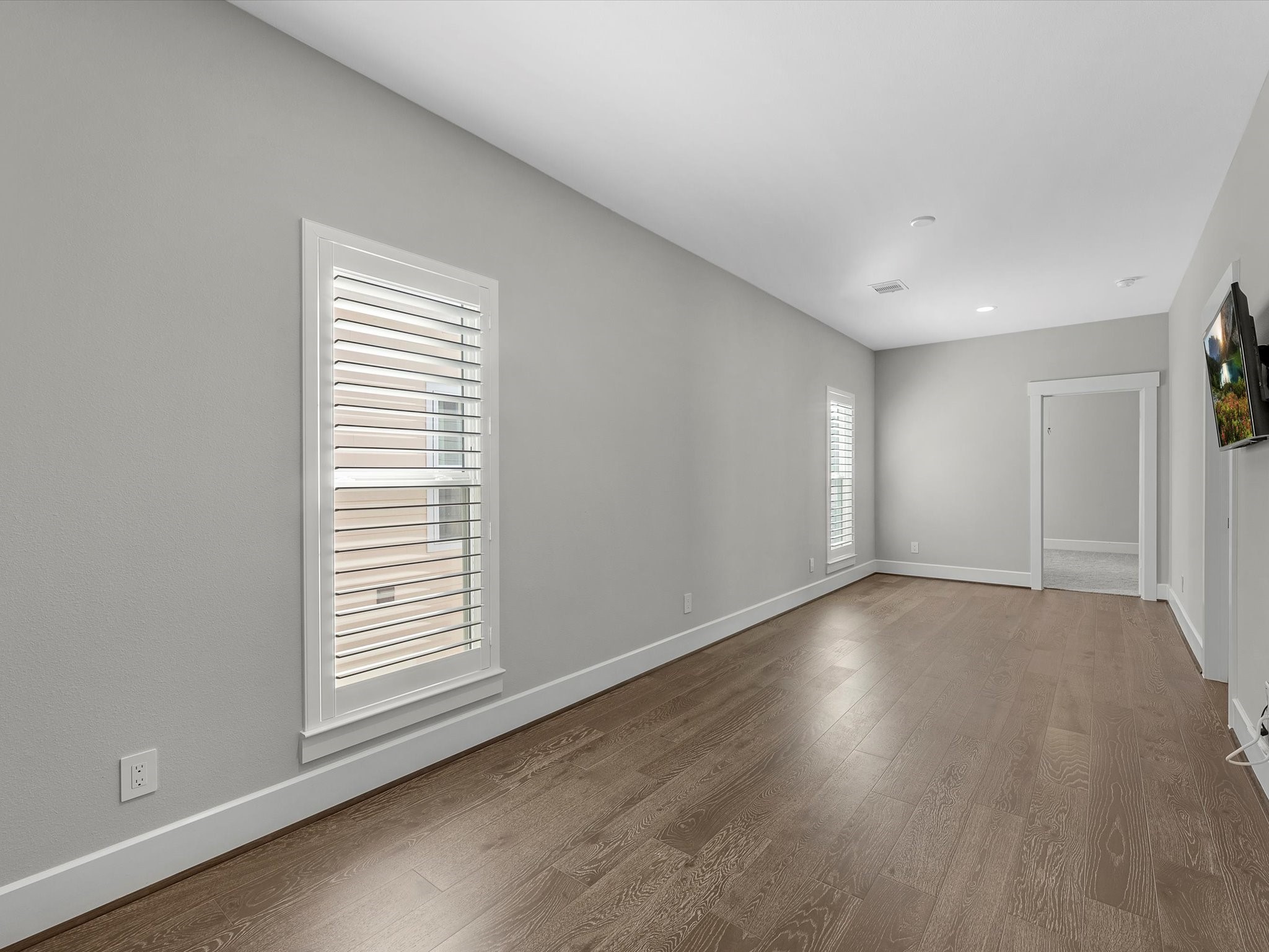 15 Black Dog Lane Spring, TX 77389 - Photo 19 of 32 a view of an empty room with wooden floor and a window