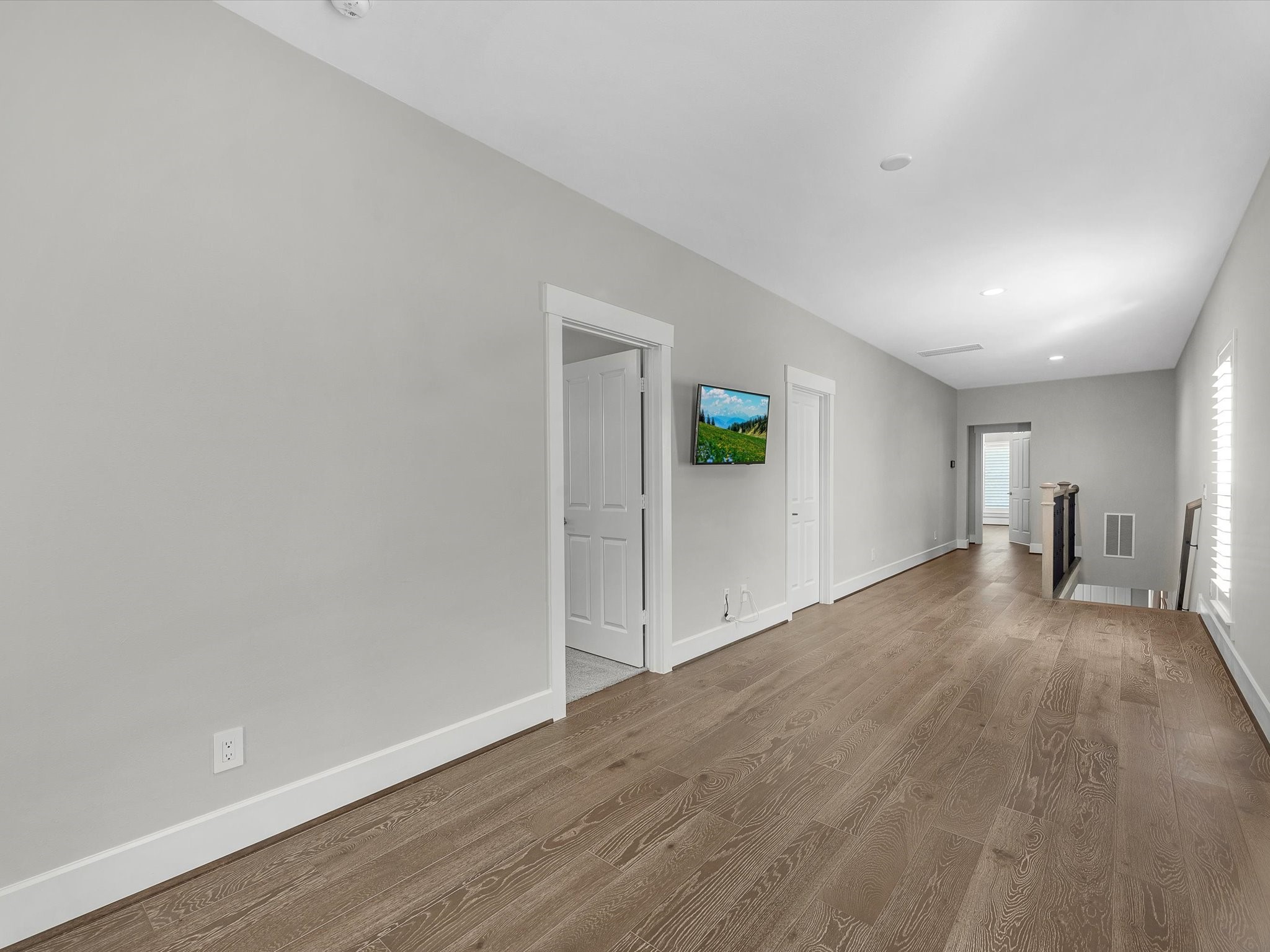 15 Black Dog Lane Spring, TX 77389 - Photo 24 of 32 a view of a livingroom with wooden floor and a ceiling fan